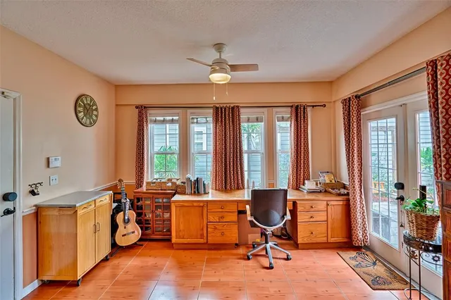 a view of a workspace with furniture and a window