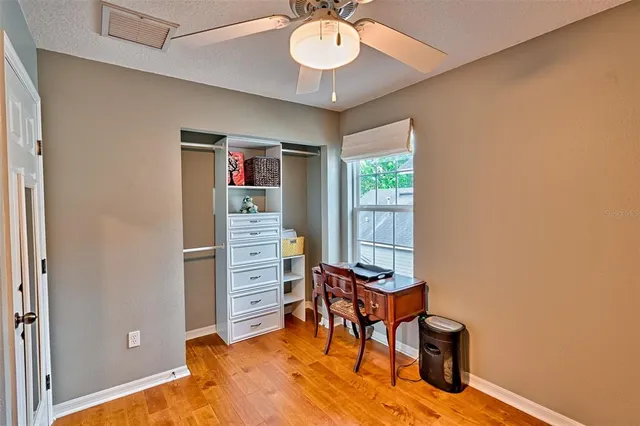 a view of a workspace with furniture and wooden floor