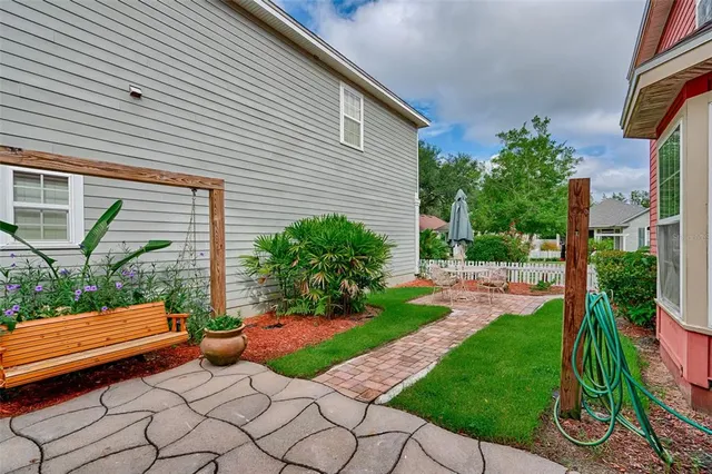 a view of a backyard with plants and a garden