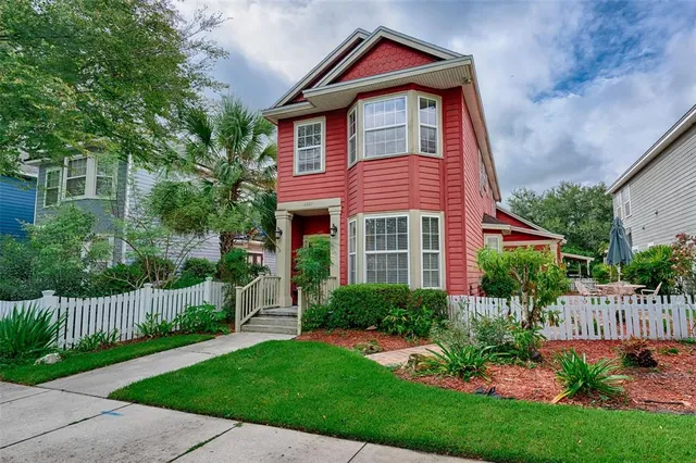 a view of a house with a small yard and plants