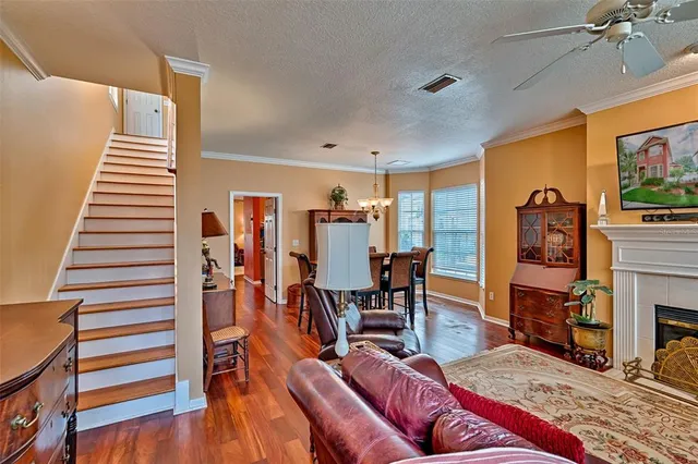 a living room with furniture a fireplace and a flat screen tv