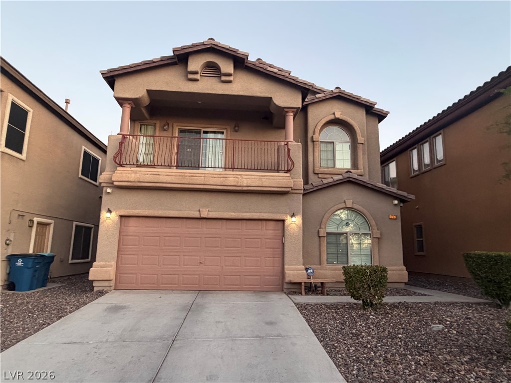 7629 Rory Court Las Vegas, NV 89129 - Photo 2 of 25 A traditional two-story residence with an inviting balcony and integrated garage.