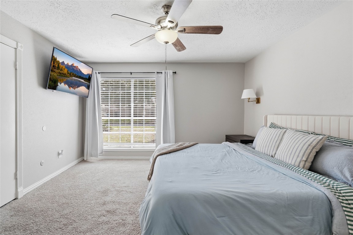 4506 Pineville Lane Spring, TX 77388 - Photo 23 of 36 Primary bedroom with soft carpeting and ceiling fan for added comfort