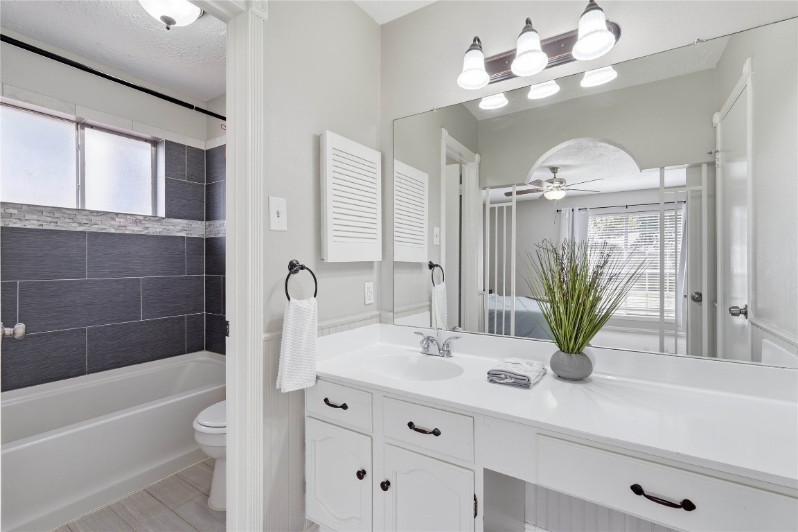 4506 Pineville Lane Spring, TX 77388 - Photo 26 of 36 a bathroom with a bathtub a sink and a large mirror