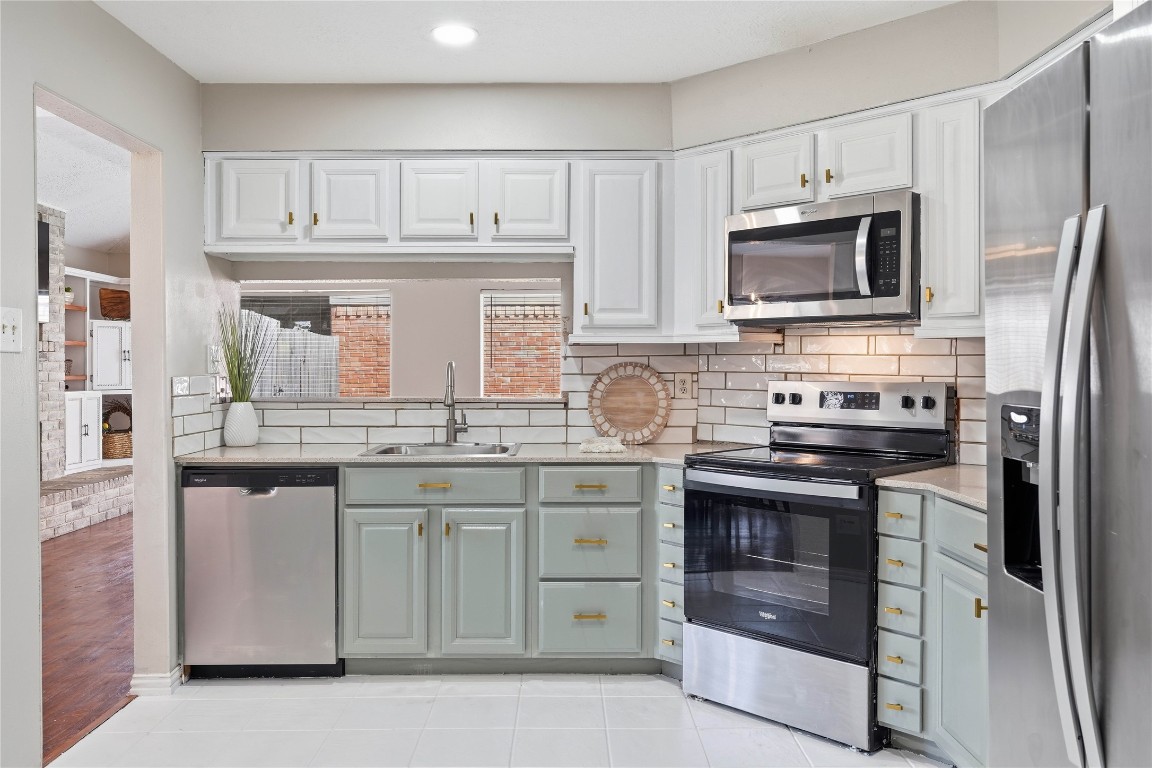 4506 Pineville Lane Spring, TX 77388 - Photo 4 of 36 a kitchen with stainless steel appliances granite countertop a stove microwave and refrigerator