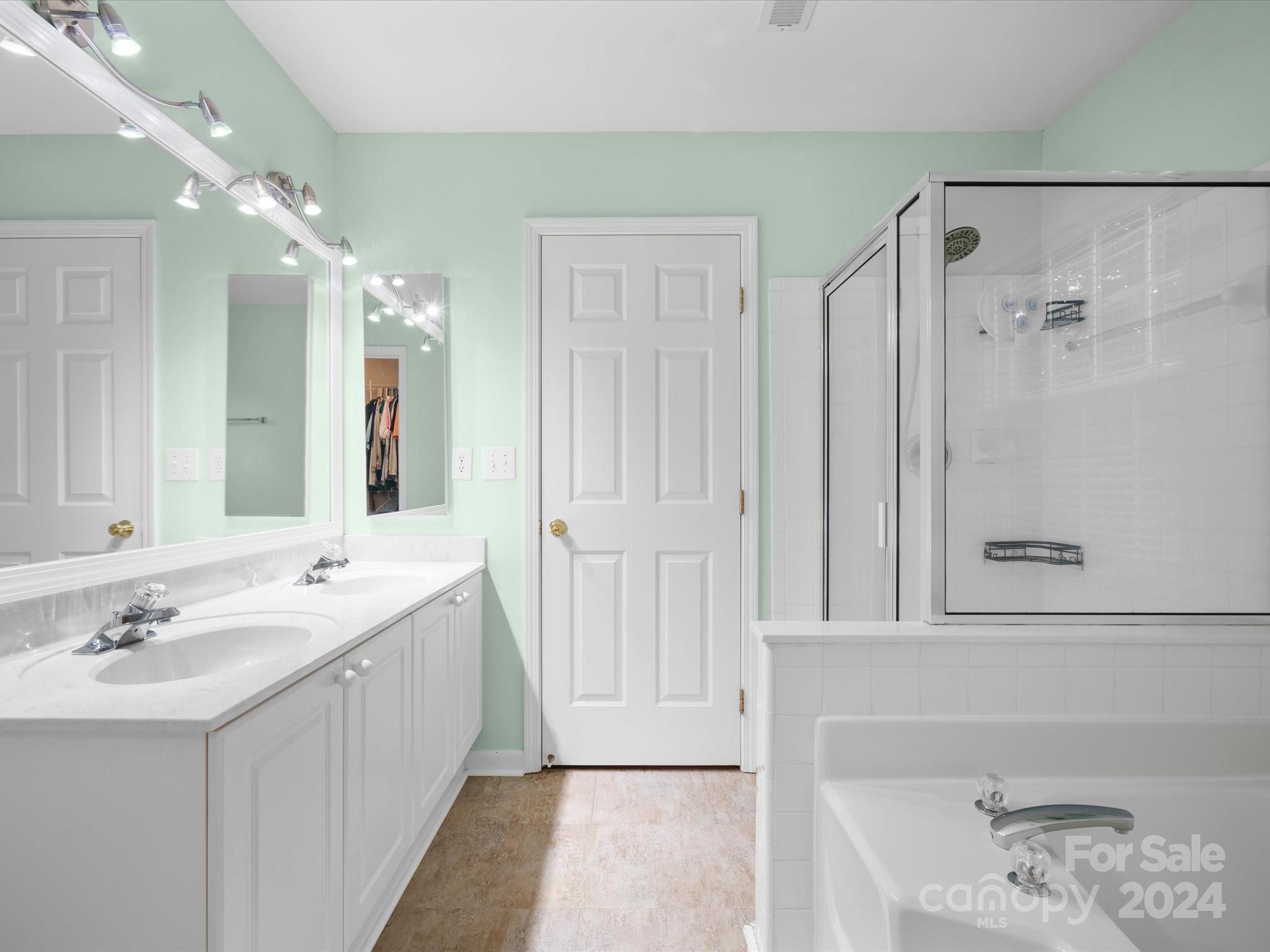 2010 Fairburn Court Fort Mill, SC 29708 - Photo 17 of 39 a large bathroom with a double vanity sink a large mirror and shower