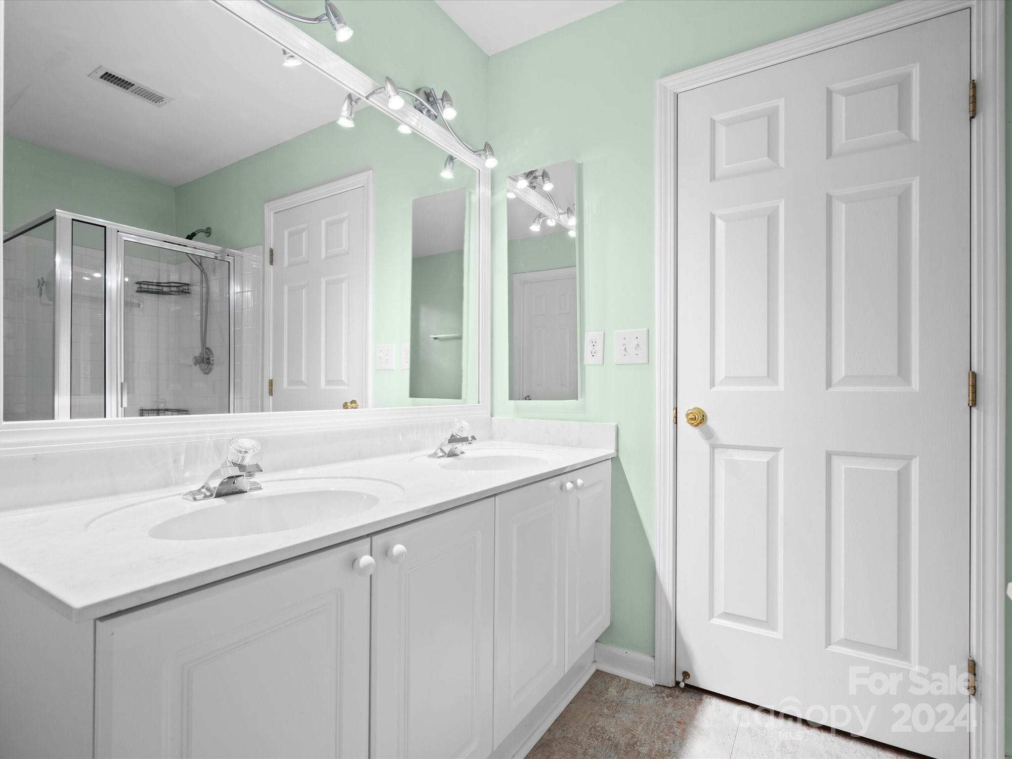 2010 Fairburn Court Fort Mill, SC 29708 - Photo 18 of 39 a bathroom with a double vanity sink and a mirror