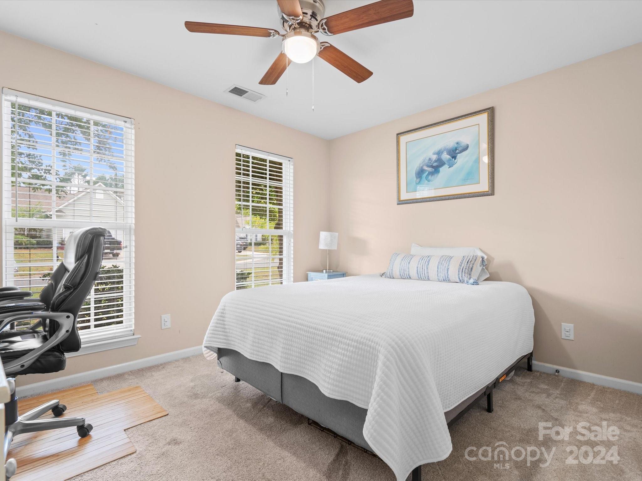2010 Fairburn Court Fort Mill, SC 29708 - Photo 22 of 39 a bedroom with a bed a chair and a large window