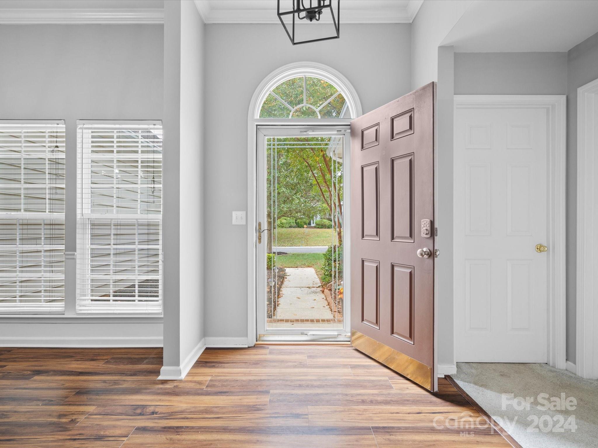 2010 Fairburn Court Fort Mill, SC 29708 - Photo 3 of 39 a view of an entryway with wooden floor mirror and a window
