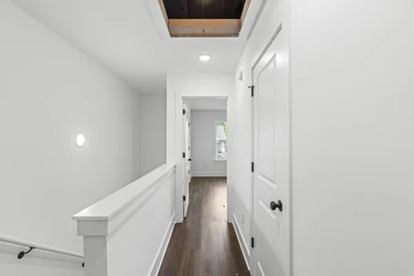 a view of a hallway with wooden floor