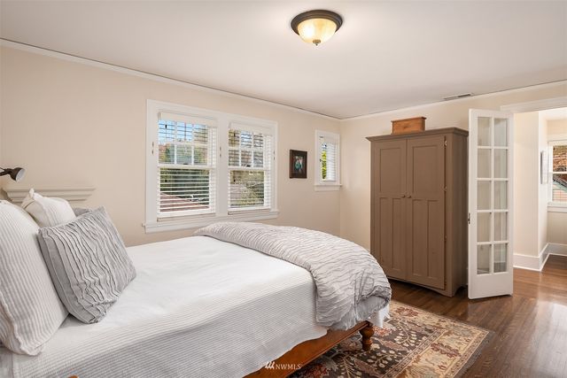a view of a patio with table and chairs potted plants and large tree