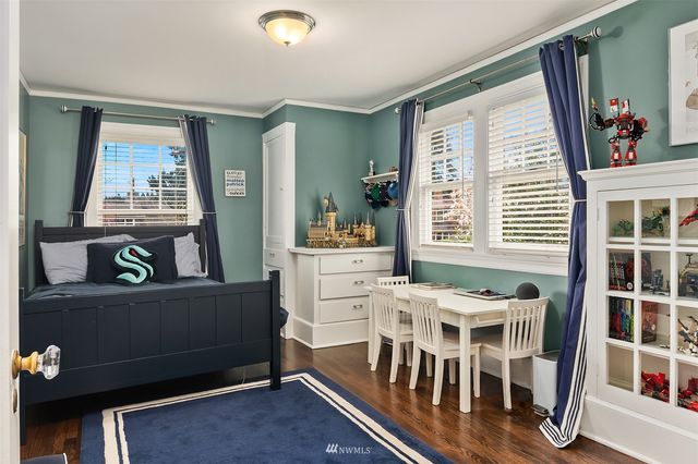 a bed sitting in a room next to a window