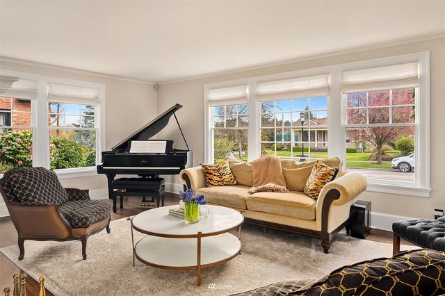 a living room with furniture fireplace and a large window