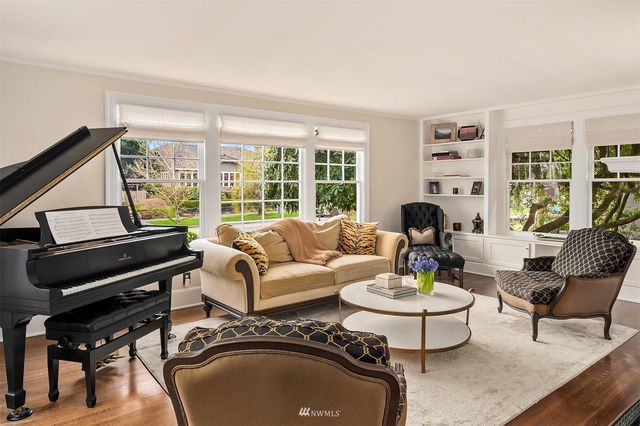 a living room with furniture fireplace and a large window