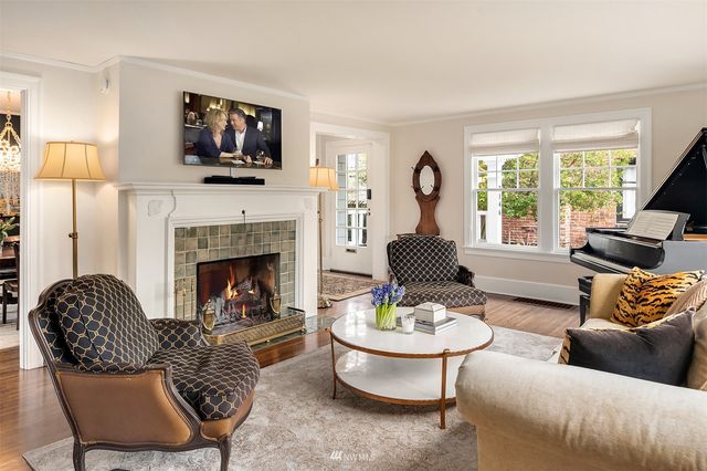 a view of a dining room with furniture large windows and wooden floor