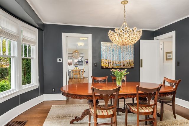 a living room with furniture a flat screen tv and a table