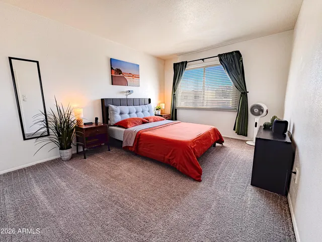 a bedroom with a bed and a dresser