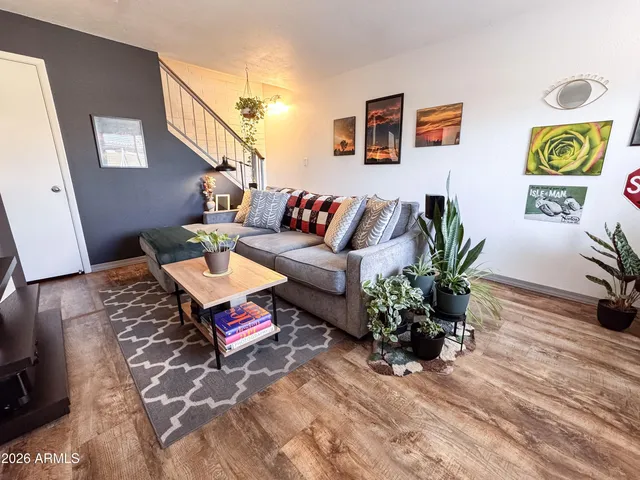 a living room with furniture and painting on the wall
