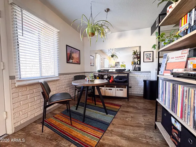 a living room with furniture a piano and a window