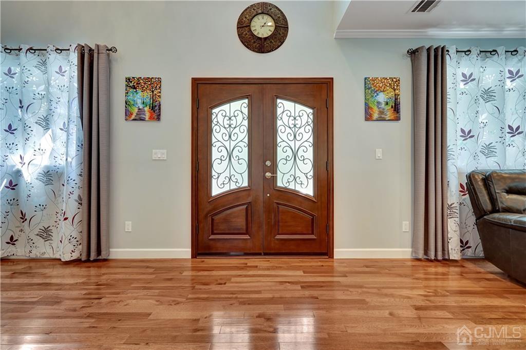 1871 Raritan Road Scotch Plains, NJ 07076 - Photo 3 of 22 a view of empty room with wooden floor and fan