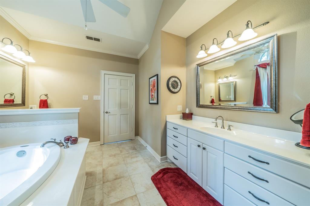 7451 County Road 1509 Athens, TX 75751 - Photo 12 of 36 a bathroom with a tub sink and mirror
