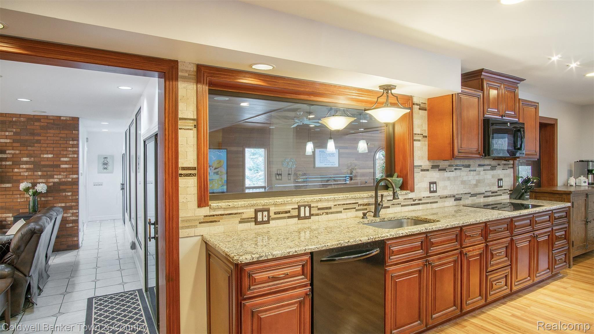 5186 Golf Club Road Howell, MI 48843 - Photo 12 of 30 Granite Kitchen with View of Pool