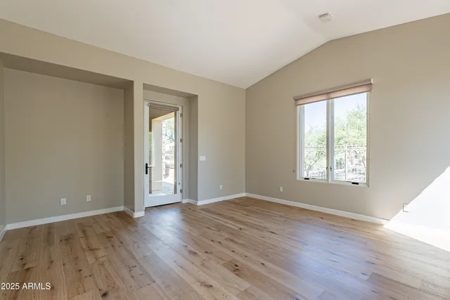 a view of an empty room with glass door