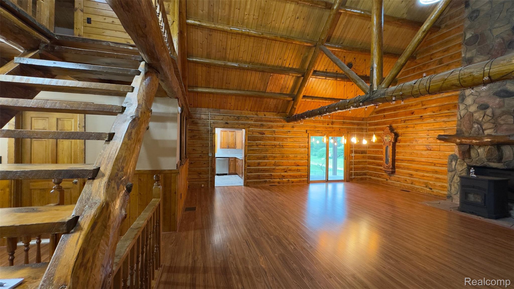 2608 East Sutton Road Metamora, MI 48455 - Photo 4 of 64 Vaulted wood-paneled ceiling with exposed log beams