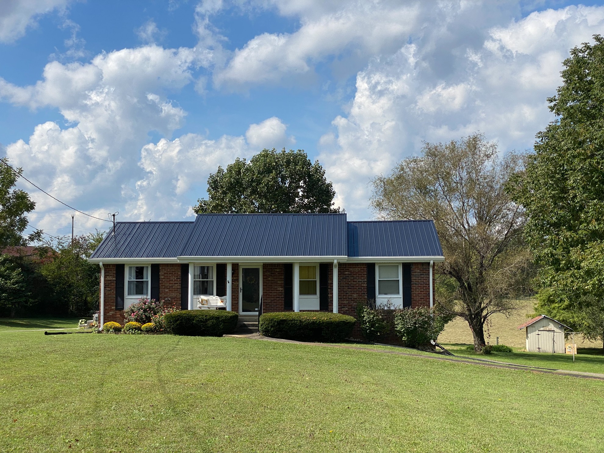 5366 Marion Road Cunningham, TN 37052 - Photo 1 of 29 a front view of a house with a garden and trees