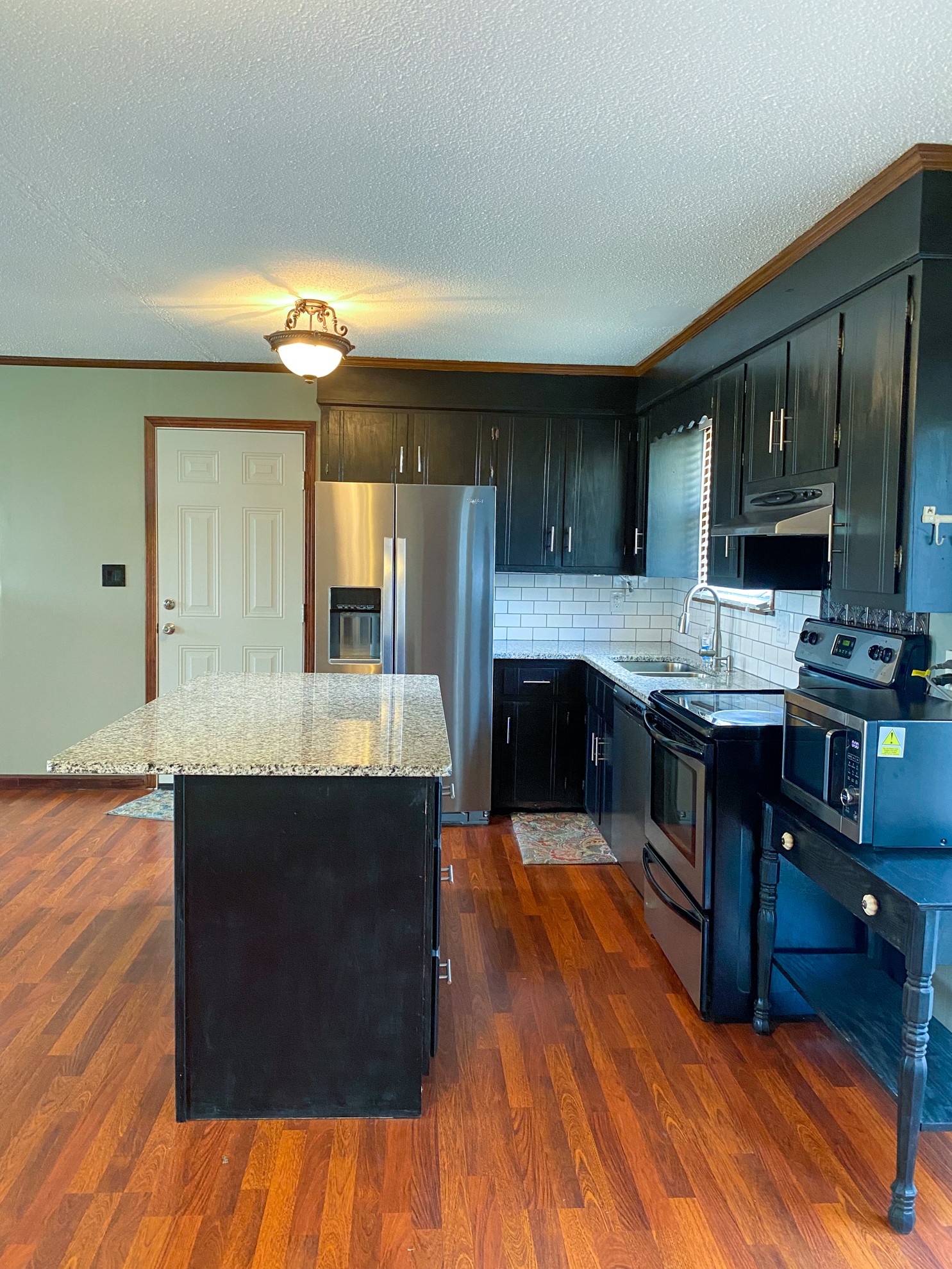 5366 Marion Road Cunningham, TN 37052 - Photo 7 of 29 a large kitchen with cabinets a sink and a stove