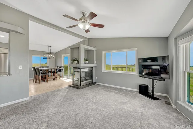 a bathroom with a granite countertop sink a toilet and a mirror