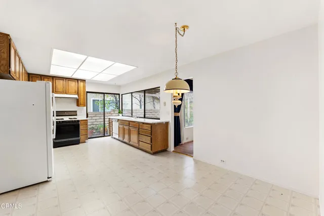 a kitchen with refrigerator a stove and cabinets