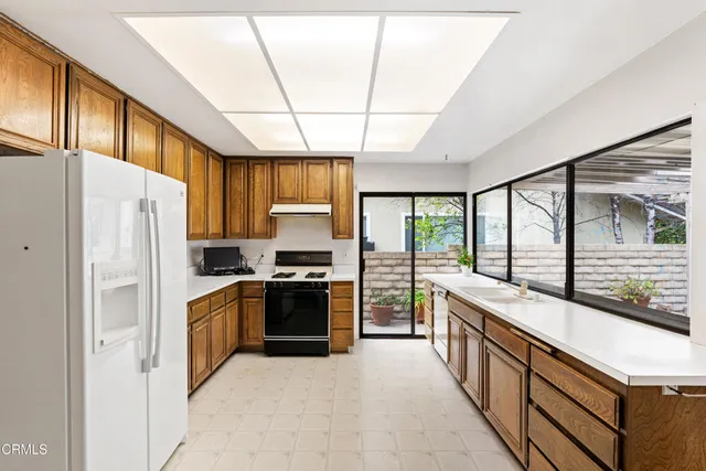 a view of a kitchen with cabinets and refrigerator