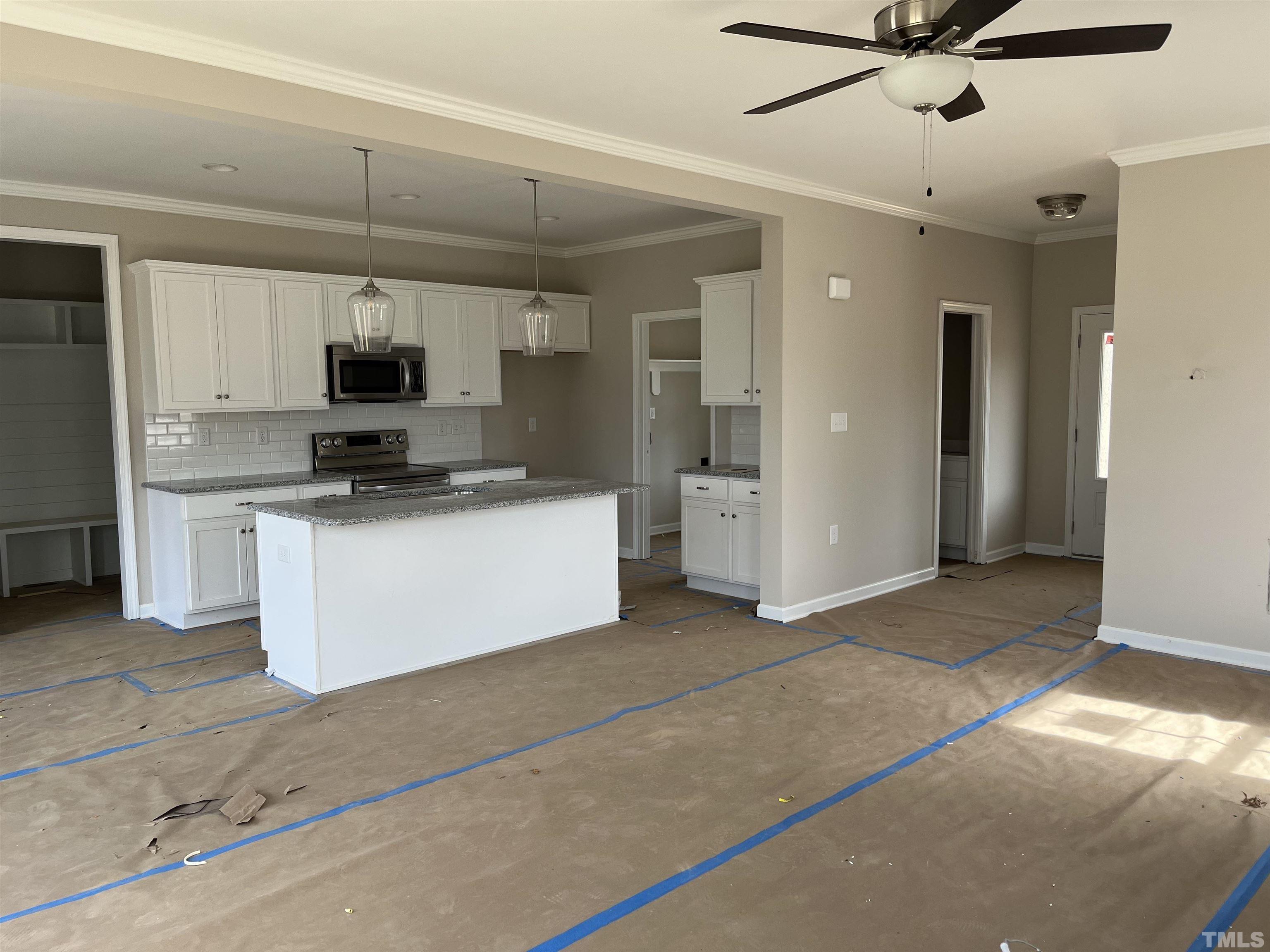 11016 Selma Road Middlesex, NC 27557 - Photo 4 of 22 a kitchen with kitchen island a white counter top space cabinets and stainless steel appliances