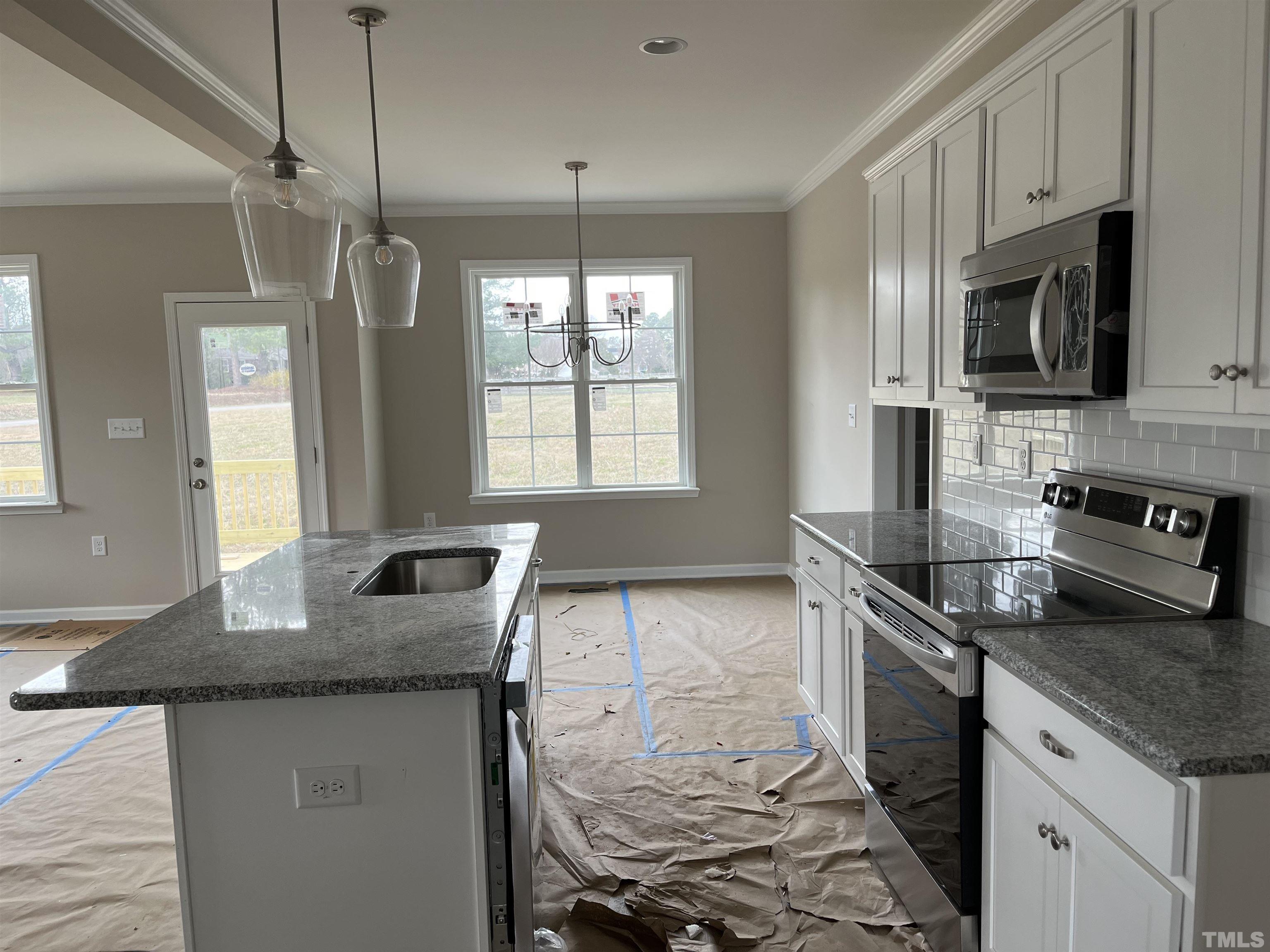 11016 Selma Road Middlesex, NC 27557 - Photo 8 of 22 a kitchen with granite countertop a sink a counter space appliances and cabinets