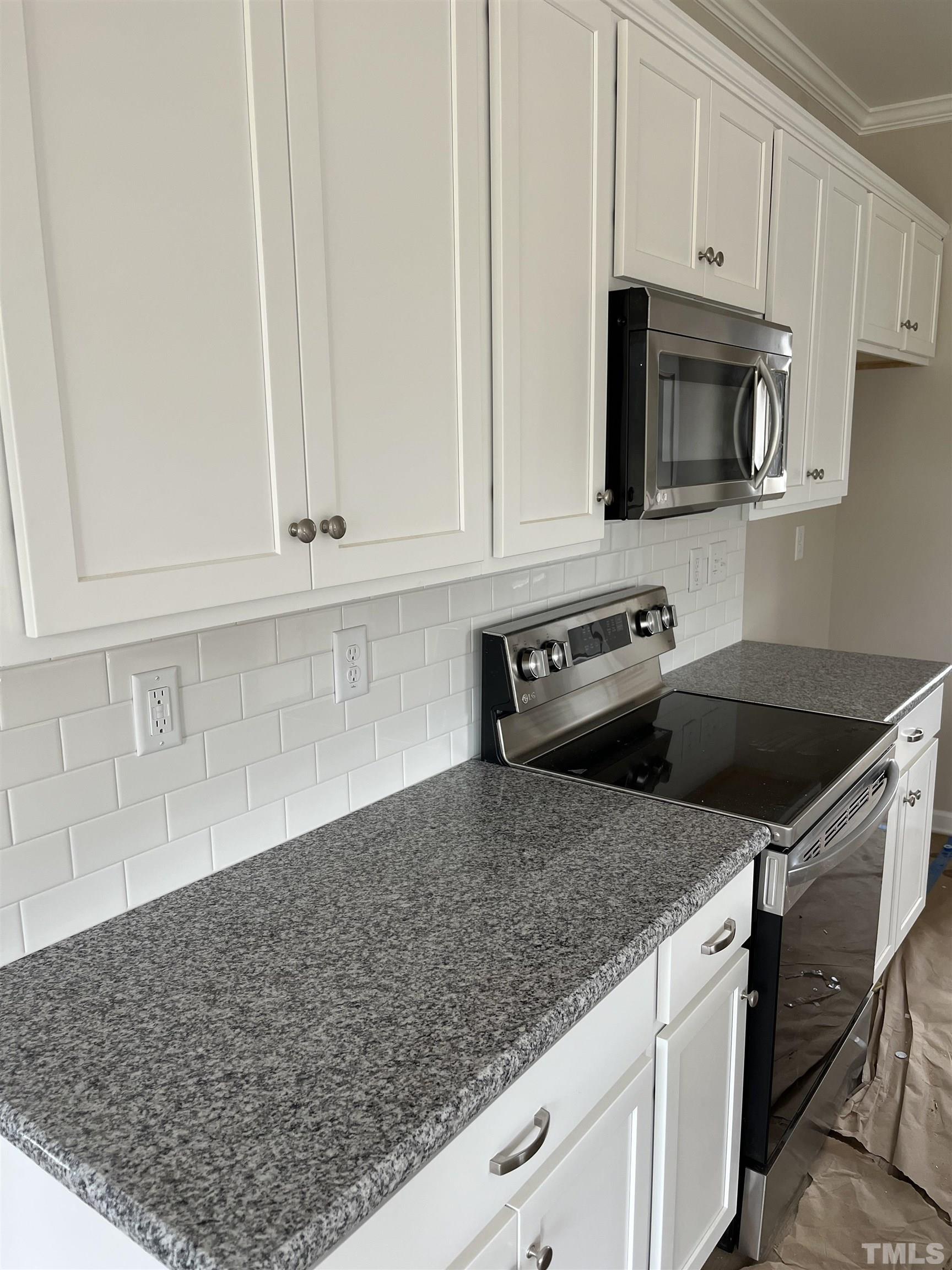 11016 Selma Road Middlesex, NC 27557 - Photo 9 of 22 a kitchen with stainless steel appliances granite countertop a sink a stove and a microwave oven