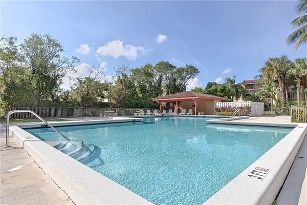 a view of a swimming pool and trees in the background