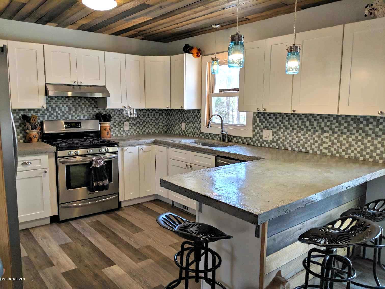 kitchen features new counters, cabinetry, and backsplash and has been completely renovated since 2016
