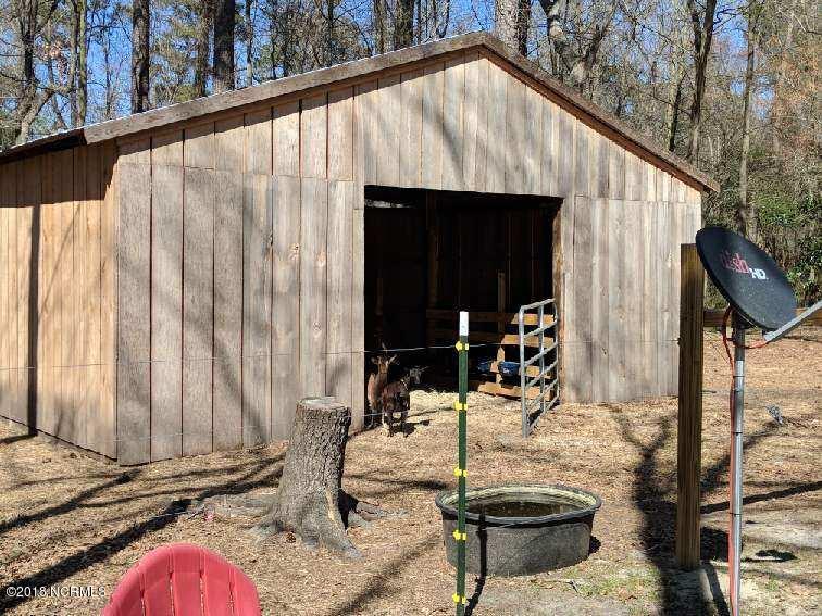 707 Blind Bridge Road Magnolia, NC 28453 - Photo 9 of 27 Barn directly behind the home is fenced for goats at this time and provides great storage or work space- a creek runs behind the barn