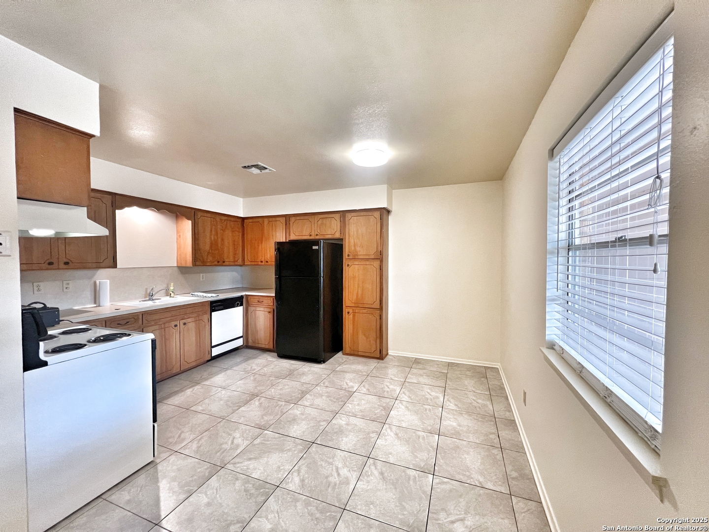 343 Bobolink Drive New Braunfels, TX 78130 - Photo 7 of 18 a kitchen with stainless steel appliances granite countertop a refrigerator and a stove top oven