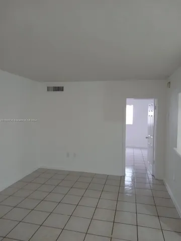 a kitchen with white cabinets and a sink
