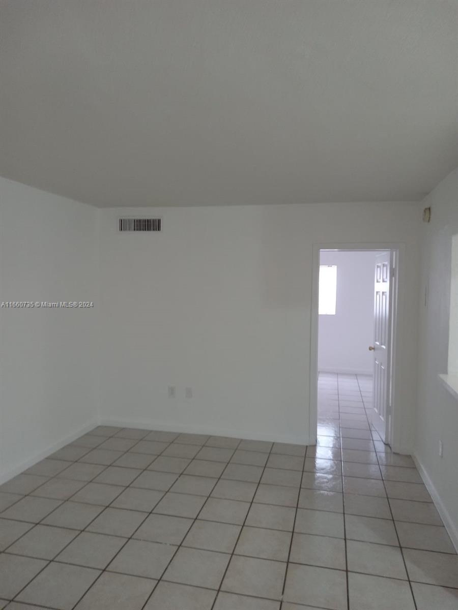 1230 West 54th Street, Unit 216A Hialeah, FL 33012 - Photo 12 of 28 a view of an empty room and window