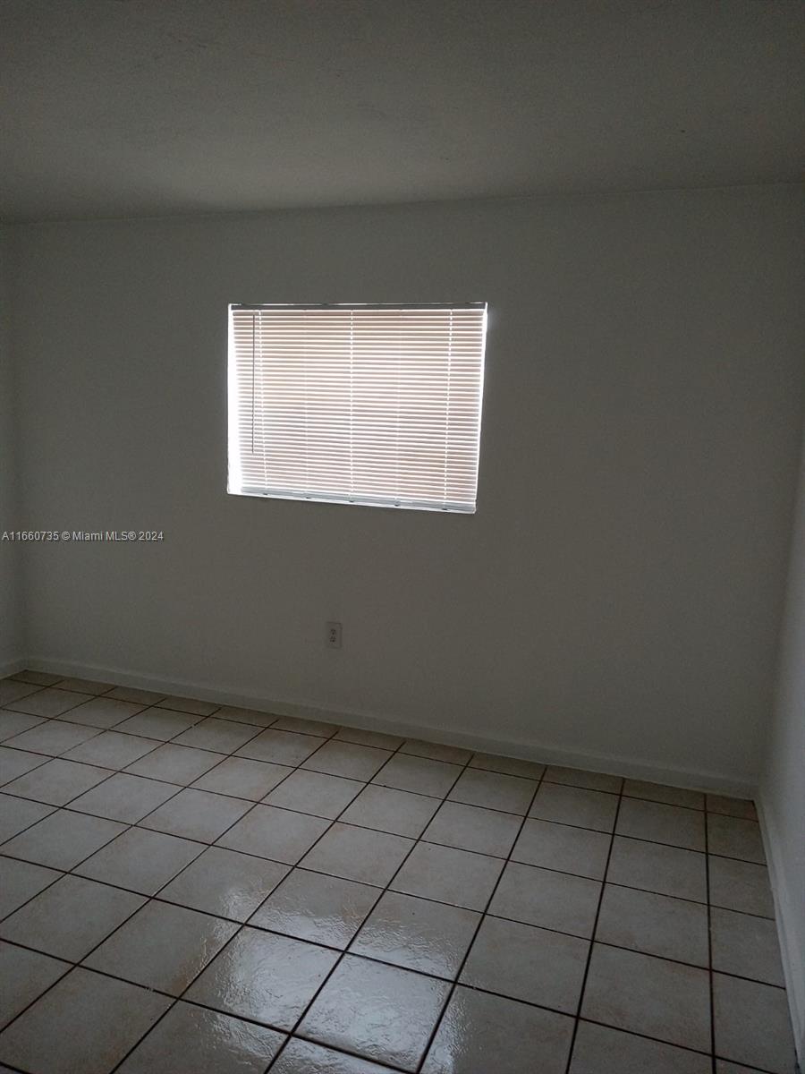1230 West 54th Street, Unit 216A Hialeah, FL 33012 - Photo 17 of 28 an empty room with a window