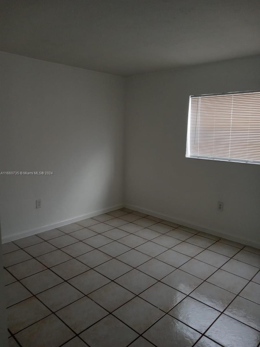 1230 West 54th Street, Unit 216A Hialeah, FL 33012 - Photo 19 of 28 an empty room with a window