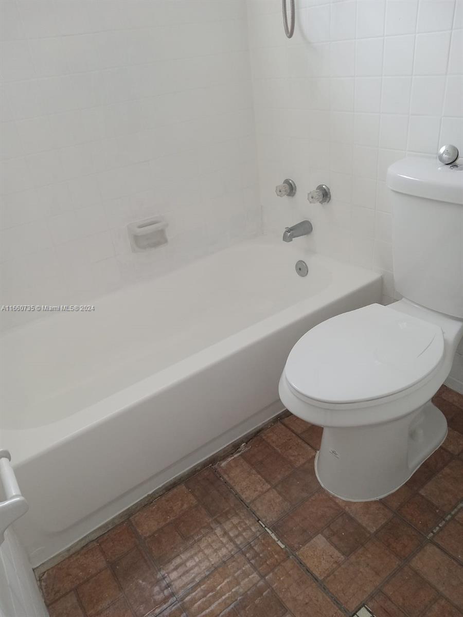 1230 West 54th Street, Unit 216A Hialeah, FL 33012 - Photo 22 of 28 a bathroom with a toilet and a bathtub