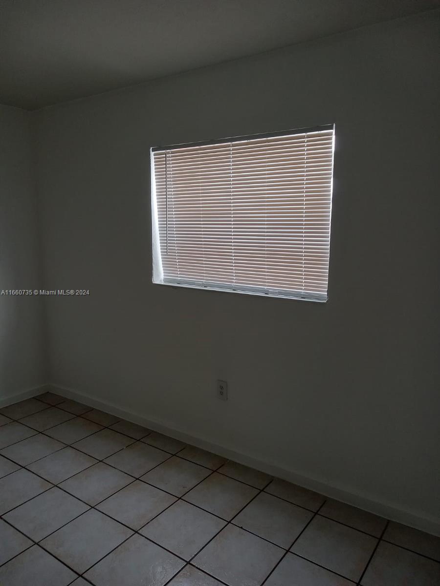 1230 West 54th Street, Unit 216A Hialeah, FL 33012 - Photo 23 of 28 an empty room with a window