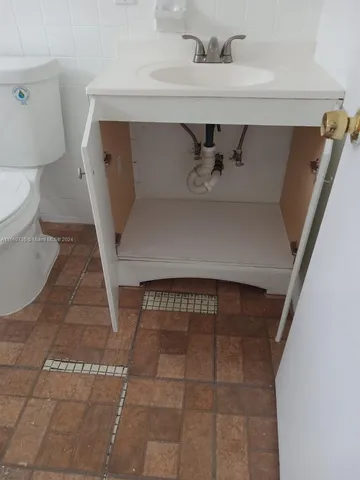 a white toilet sitting next to a bath tub