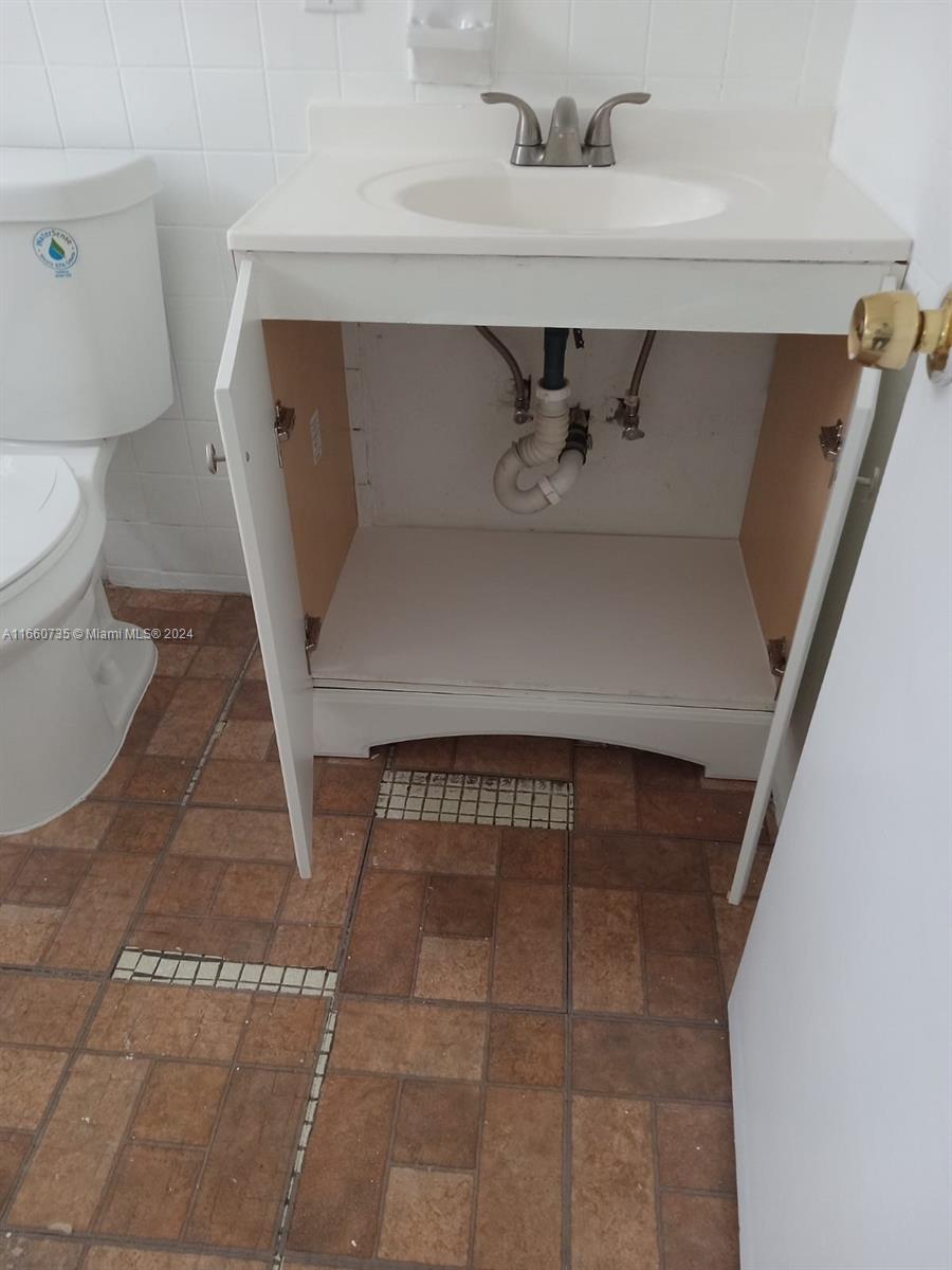 1230 West 54th Street, Unit 216A Hialeah, FL 33012 - Photo 24 of 28 a bathroom with a sink and toilet