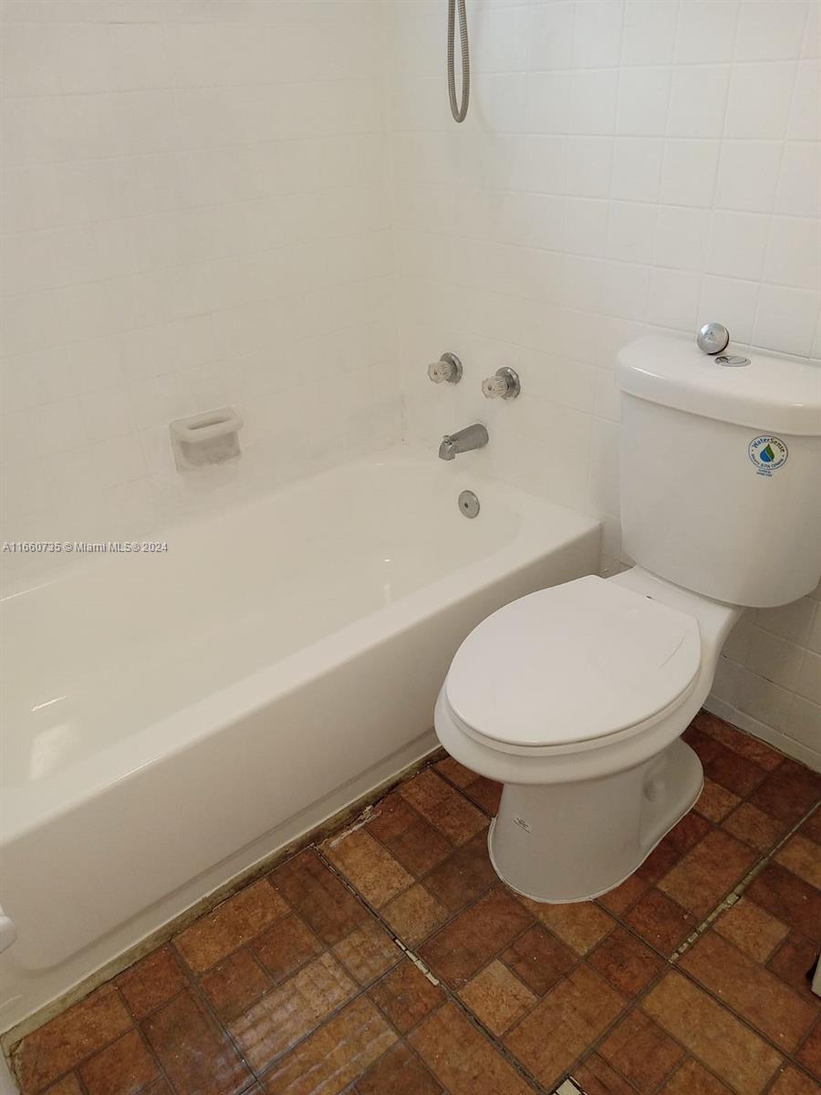 1230 West 54th Street, Unit 216A Hialeah, FL 33012 - Photo 25 of 28 a white toilet sitting next to a bath tub