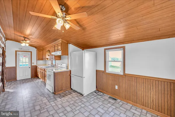 a view of a kitchen with furniture and cabinets